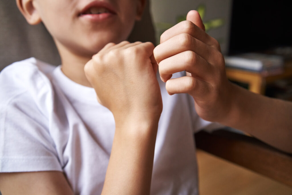 child practicing eft emotional freedom technique tapping on karate chop point